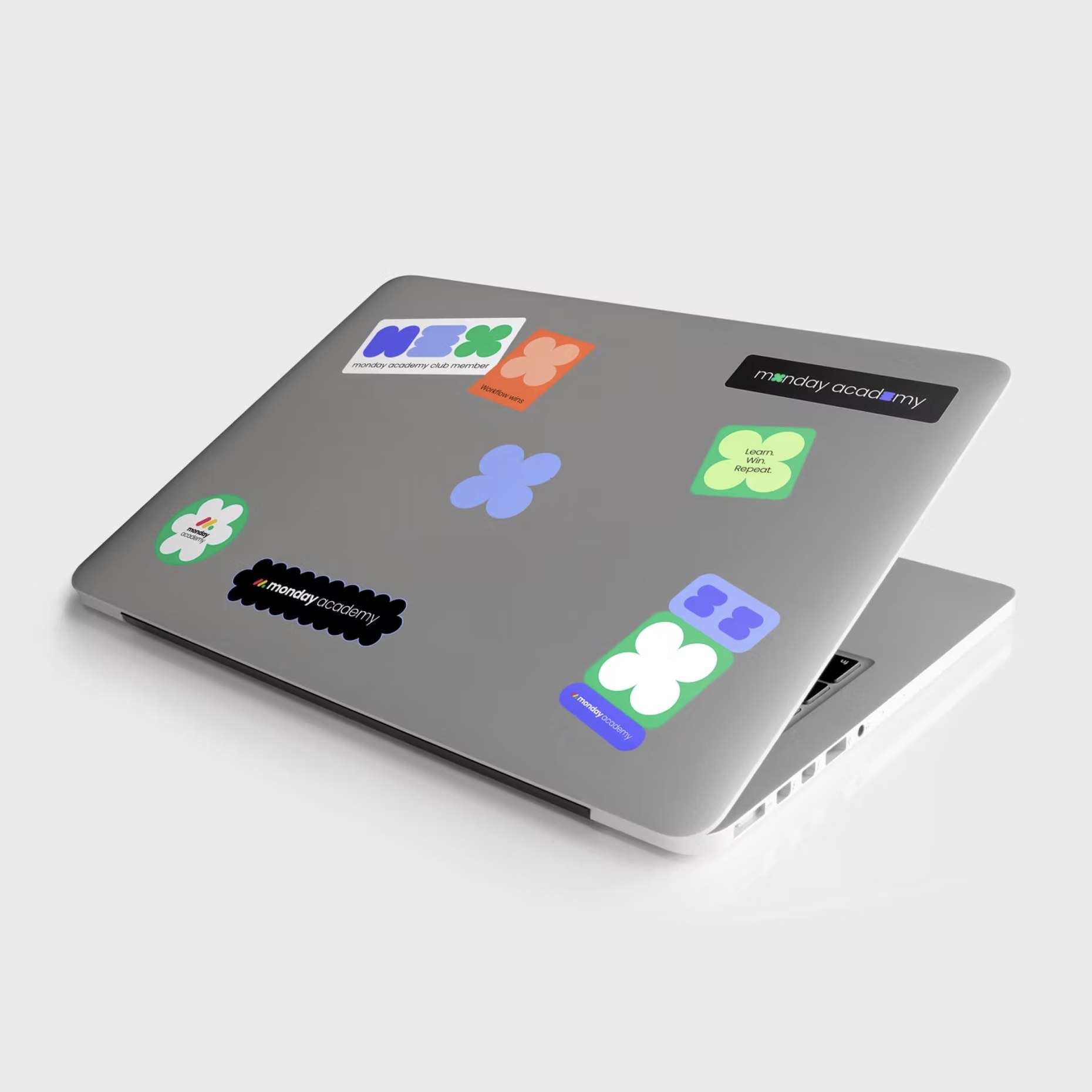 Laptop covered in monday academy stickers