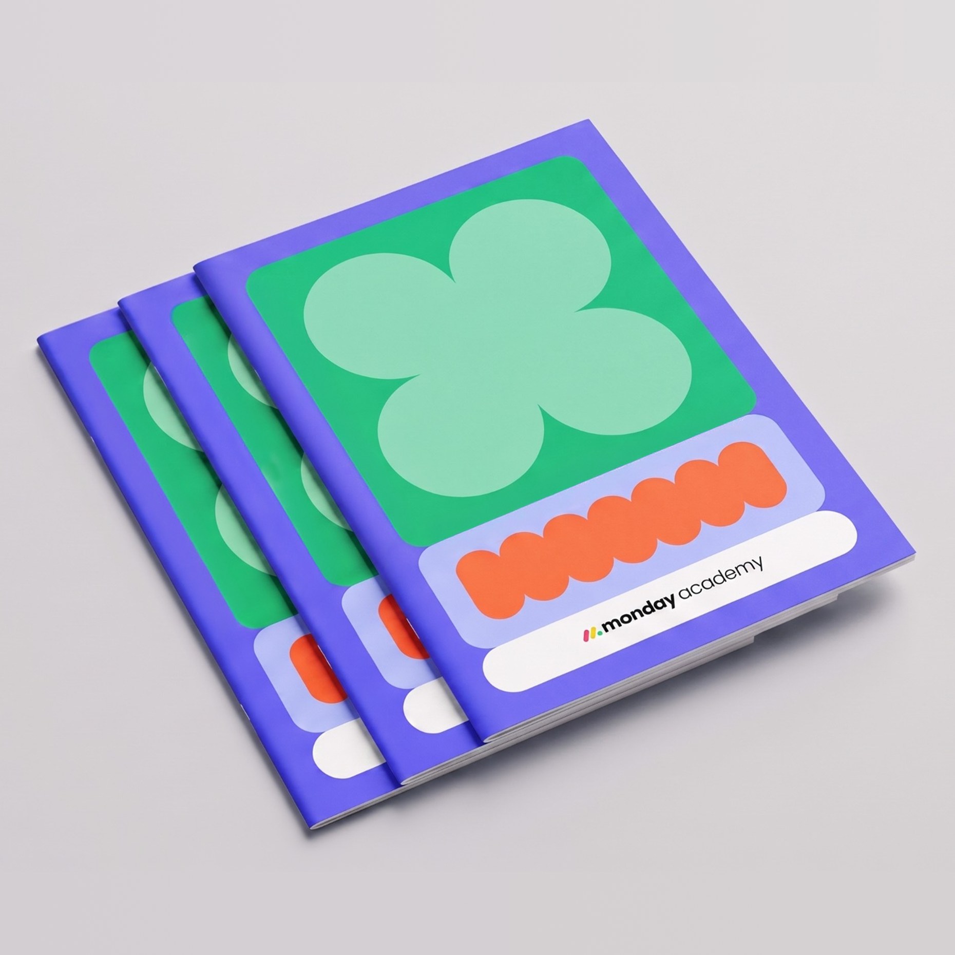 Stack of violet monday academy notebooks